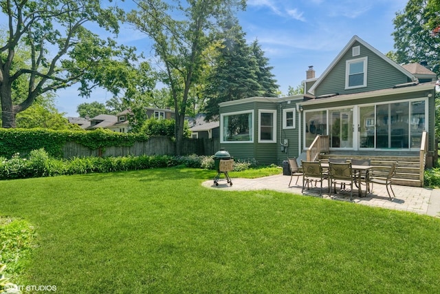 2617 Thayer St, Evanston, IL 60201 - rear view of house with a patio, a chimney, and a sunroom