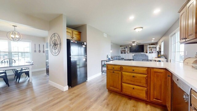1313 W Ridge Ln, Champaign, IL 61822 - kitchen with freestanding refrigerator, stainless steel dishwasher, a peninsula, ceiling fan, and a chandelier
