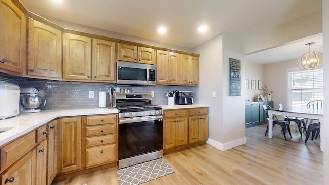 1313 W Ridge Ln, Champaign, IL 61822 - kitchen with appliances with stainless steel finishes, light wood finished floors, light countertops, tasteful backsplash, and recessed lighting