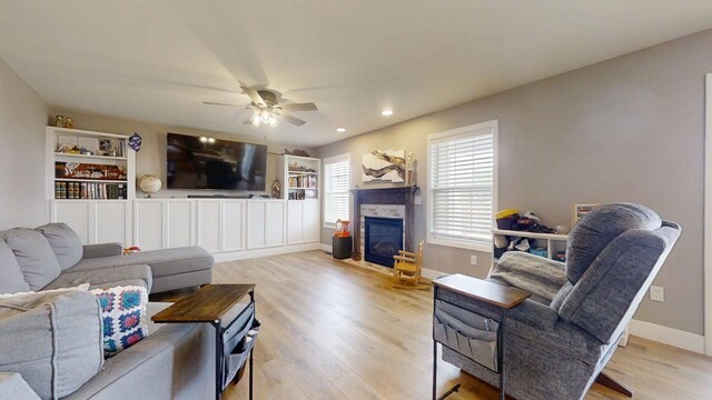 1313 W Ridge Ln, Champaign, IL 61822 - living room featuring light wood-type flooring, ceiling fan, a stone fireplace, and recessed lighting
