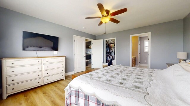 1313 W Ridge Ln, Champaign, IL 61822 - bedroom with light wood-style floors, a spacious closet, ensuite bathroom, a closet, and a ceiling fan