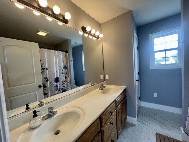 1313 W Ridge Ln, Champaign, IL 61822 - bathroom featuring double vanity, marble look tiles, and a shower with shower curtain