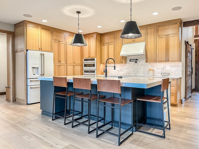 26205 W Forrester Dr, Plainfield, IL 60585 - kitchen with high end white refrigerator, under cabinet range hood, light wood-style flooring, double oven, and light countertops