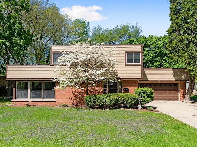 225 S Gladstone Ave, Aurora, IL 60506 - view of front of home with brick siding, a garage, a front lawn, and concrete driveway