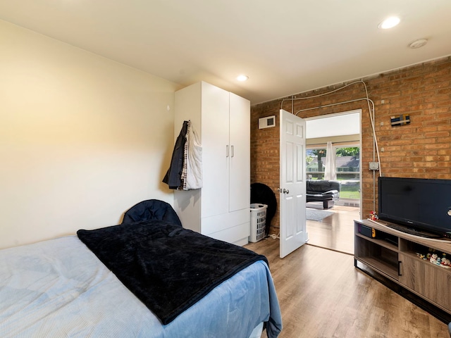 225 S Gladstone Ave, Aurora, IL 60506 - bedroom with wood finished floors, brick wall, and recessed lighting