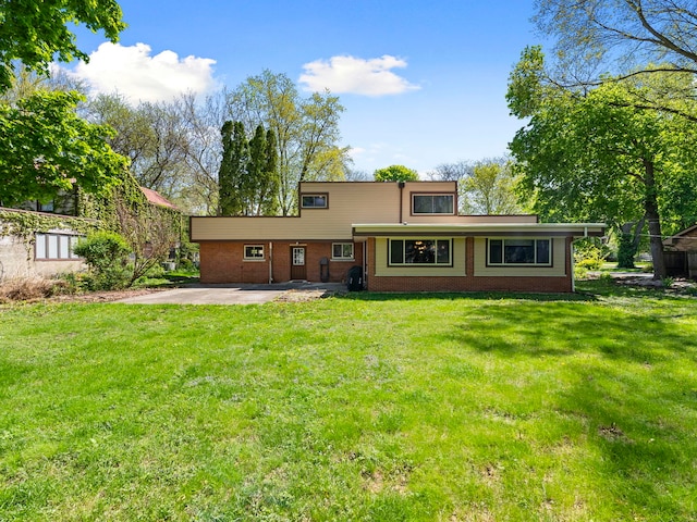 225 S Gladstone Ave, Aurora, IL 60506 - back of house featuring brick siding, a yard, and a patio area
