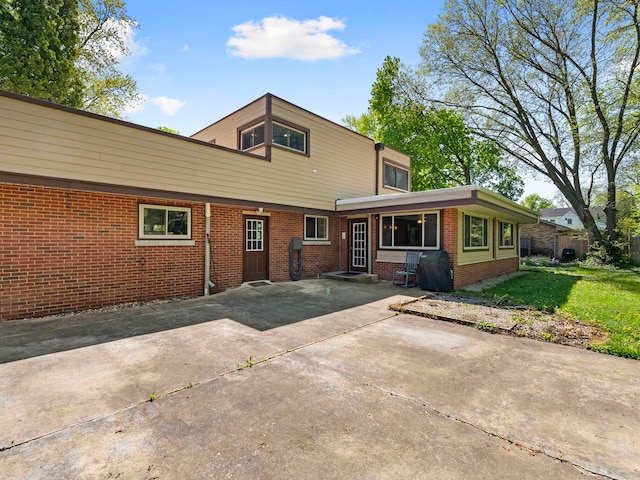 225 S Gladstone Ave, Aurora, IL 60506 - back of house featuring brick siding and a yard