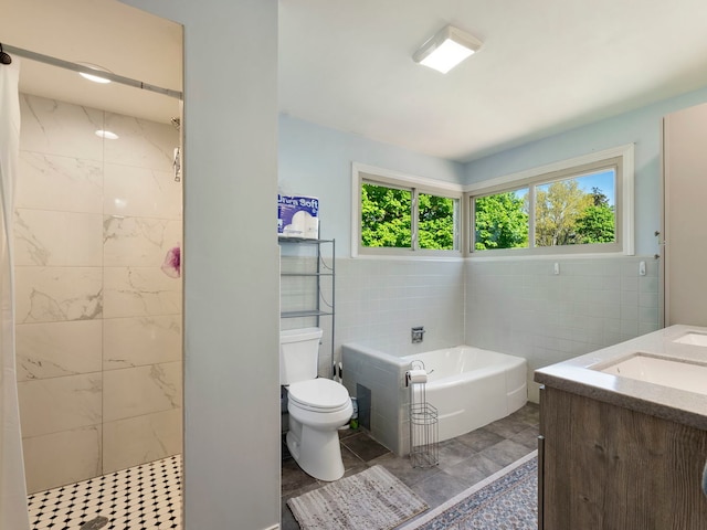225 S Gladstone Ave, Aurora, IL 60506 - bathroom featuring tile walls, a bath, toilet, double vanity, and a tile shower