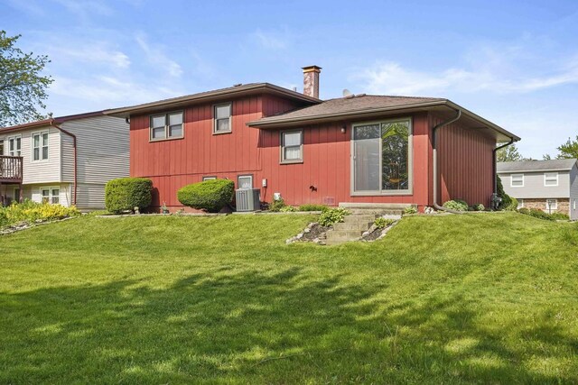 20048 Orchard Ave, Lynwood, IL 60411 - back of house featuring central AC unit, a lawn, and a chimney