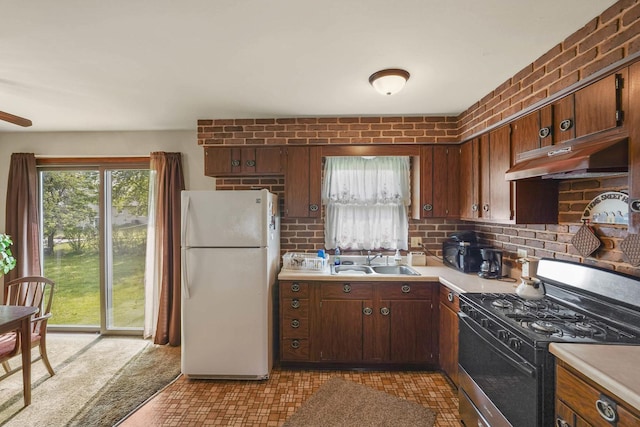 20048 Orchard Ave, Lynwood, IL 60411 - kitchen featuring freestanding refrigerator, black gas range, a sink, under cabinet range hood, and light countertops