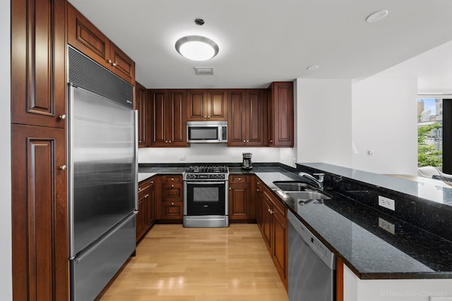 60 E Monroe St Unit 1604, Chicago, IL 60603 - kitchen featuring stainless steel appliances, a sink, light wood-type flooring, a peninsula, and dark stone counters