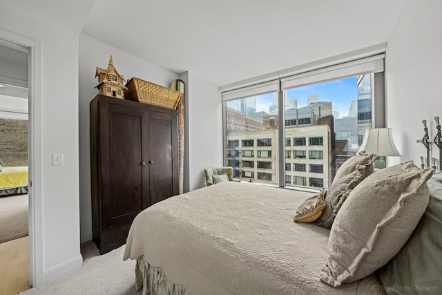 60 E Monroe St Unit 1604, Chicago, IL 60603 - bedroom featuring a view of city, a wall of windows, and baseboards