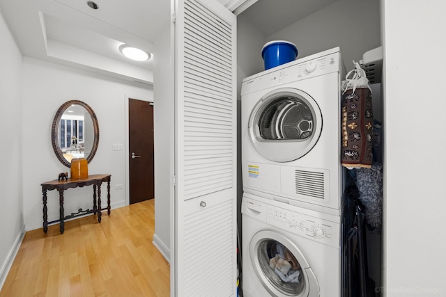 60 E Monroe St Unit 1604, Chicago, IL 60603 - laundry area with stacked washer / drying machine, light wood-type flooring, and baseboards