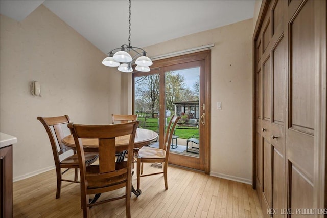 554 Carriage Hill Rd, Naperville, IL 60565 - dining space with a chandelier, light wood finished floors, baseboards, and lofted ceiling