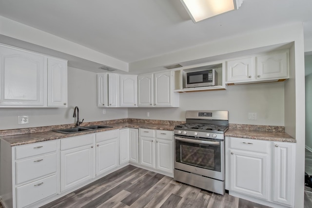 506 Sunrise Dr, Mchenry, IL 60051 - kitchen featuring stainless steel appliances, a sink, dark wood-style floors, and white cabinetry