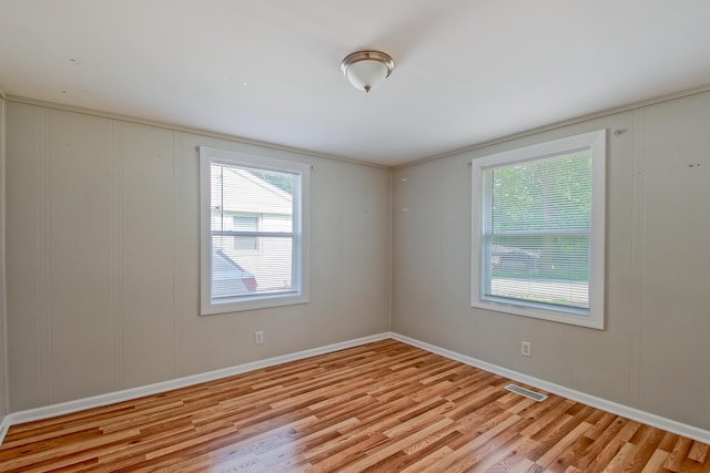 506 Sunrise Dr, Mchenry, IL 60051 - spare room featuring wood finished floors, a decorative wall, plenty of natural light, and baseboards