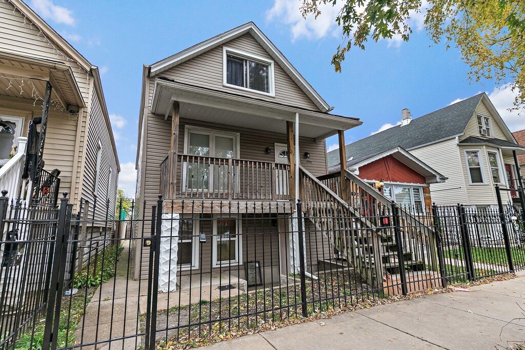 2214 N Mango Ave, Chicago, IL 60639 - view of front of property featuring stairway, a porch, and a fenced front yard