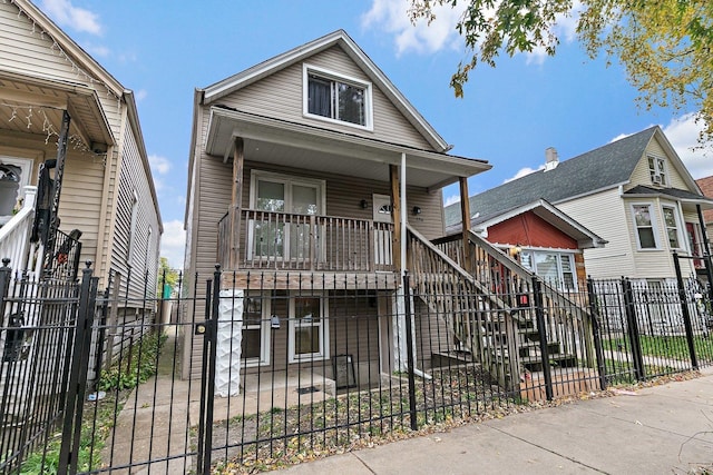 2214 N Mango Ave, Chicago, IL 60639 - view of front of property featuring stairway, a porch, and a fenced front yard