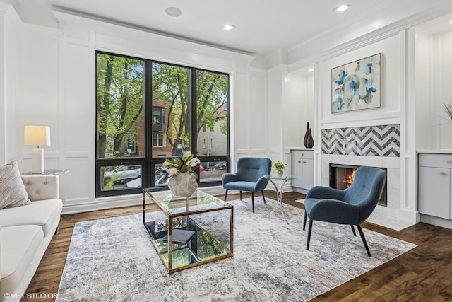 1717 W Huron St, Chicago, IL 60622 - living area with a decorative wall, a tile fireplace, wood finished floors, crown molding, and recessed lighting