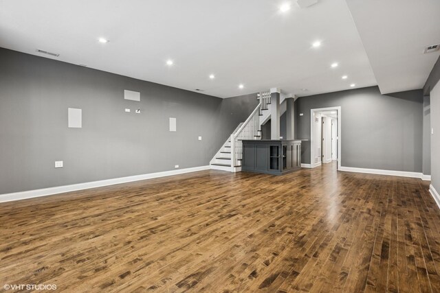 1717 W Huron St, Chicago, IL 60622 - unfurnished living room with dark wood-style flooring, baseboards, recessed lighting, and stairs