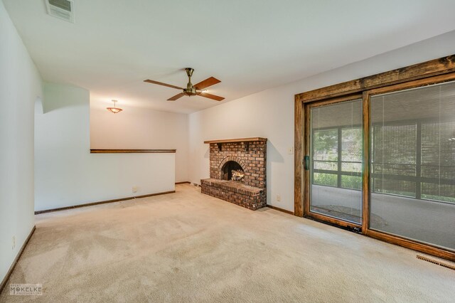 337 George St, Sycamore, IL 60178 - unfurnished living room featuring carpet flooring, a ceiling fan, and a fireplace