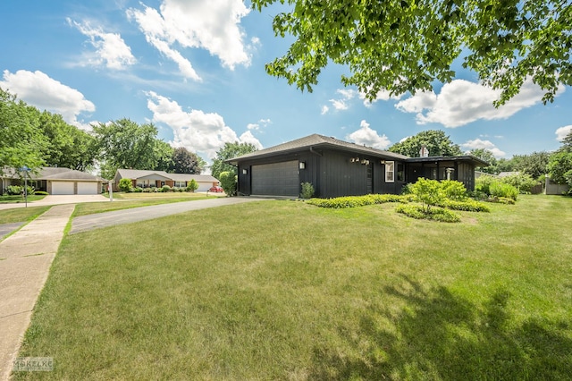 337 George St, Sycamore, IL 60178 - view of side of property featuring concrete driveway, a lawn, and an attached garage