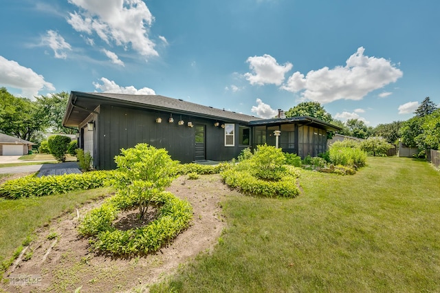 337 George St, Sycamore, IL 60178 - back of property featuring a yard, board and batten siding, and a sunroom