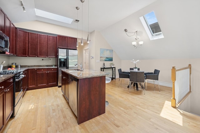 1325 W Wolfram St Unit 3, Chicago, IL 60657 - kitchen with a skylight, appliances with stainless steel finishes, reddish brown cabinets, light wood finished floors, and vaulted ceiling