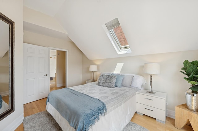 1325 W Wolfram St Unit 3, Chicago, IL 60657 - bedroom with vaulted ceiling, a skylight, light wood-style floors, and baseboards
