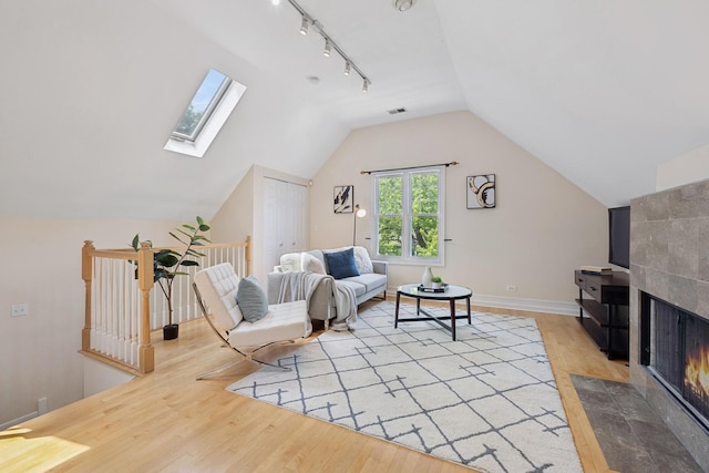 1325 W Wolfram St Unit 3, Chicago, IL 60657 - living area with an upstairs landing, light wood-style flooring, vaulted ceiling, a skylight, and baseboards