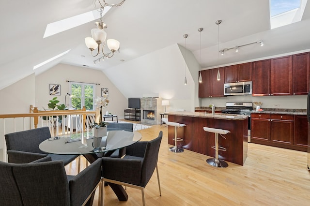 1325 W Wolfram St Unit 3, Chicago, IL 60657 - dining area featuring a skylight, light wood-style floors, and vaulted ceiling