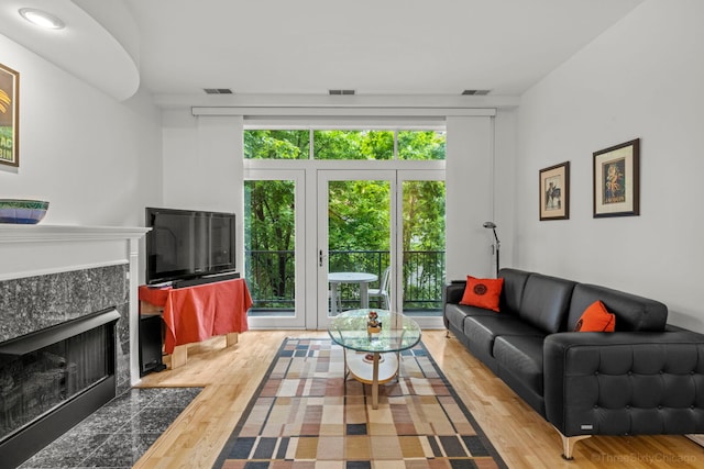 333 N Jefferson St Unit 307, Chicago, IL 60661 - living room featuring a premium fireplace, healthy amount of natural light, and wood finished floors