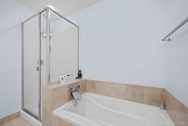 333 N Jefferson St Unit 307, Chicago, IL 60661 - bathroom featuring a shower stall, a bath, and tile patterned floors