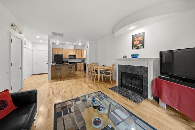 333 N Jefferson St Unit 307, Chicago, IL 60661 - living area with light wood finished floors, a tiled fireplace, and recessed lighting