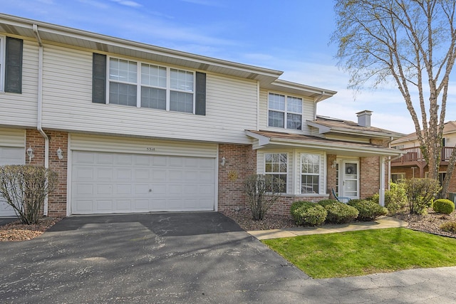 5318 W Dixie Dr Unit 10, Alsip, IL 60803 - view of property featuring a garage, brick siding, and asphalt driveway