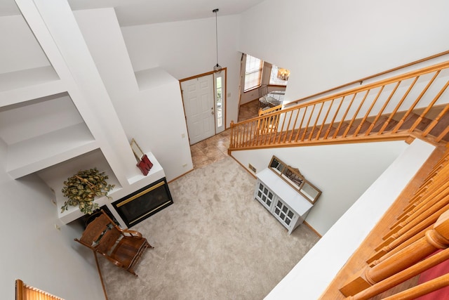 5318 W Dixie Dr Unit 10, Alsip, IL 60803 - unfurnished living room with high vaulted ceiling, stairs, and carpet