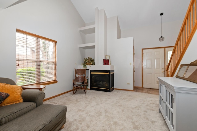 5318 W Dixie Dr Unit 10, Alsip, IL 60803 - living area featuring high vaulted ceiling, a glass covered fireplace, stairway, light carpet, and baseboards