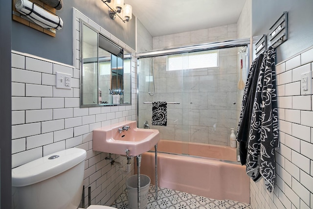 329 W Wood Ave, Peotone, IL 60468 - full bathroom featuring tile walls, toilet, bath / shower combo with glass door, a sink, and tile patterned flooring