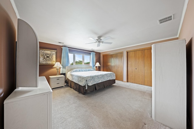 8964 Dublin St Unit 12C, Orland Park, IL 60462 - bedroom featuring light carpet, multiple closets, a ceiling fan, and crown molding