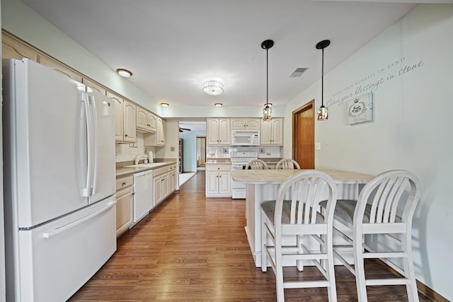 8964 Dublin St Unit 12C, Orland Park, IL 60462 - kitchen with white appliances, a breakfast bar area, wood finished floors, and light countertops