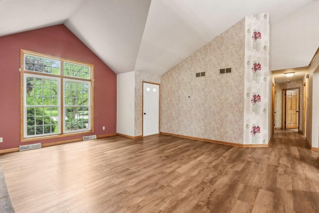 N61W14730 Woodcrest Ct, Menomonee Falls, WI 53051 - unfurnished living room with wood finished floors, vaulted ceiling, and baseboards