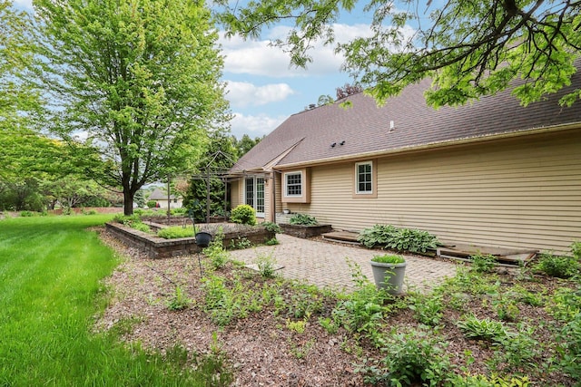 N61W14730 Woodcrest Ct, Menomonee Falls, WI 53051 - back of house with a patio area, a yard, and a shingled roof
