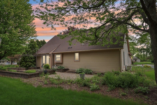 N61W14730 Woodcrest Ct, Menomonee Falls, WI 53051 - property exterior at dusk featuring a shingled roof