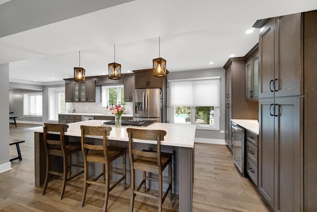 12533 Rosewood Dr, Homer Glen, IL 60491 - kitchen featuring stainless steel appliances, wine cooler, dark brown cabinets, glass insert cabinets, and recessed lighting