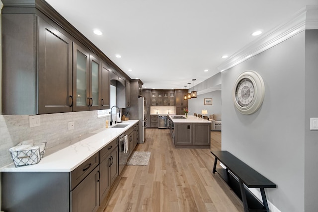 12533 Rosewood Dr, Homer Glen, IL 60491 - kitchen with stainless steel appliances, ornamental molding, light wood-type flooring, light countertops, and dark brown cabinets