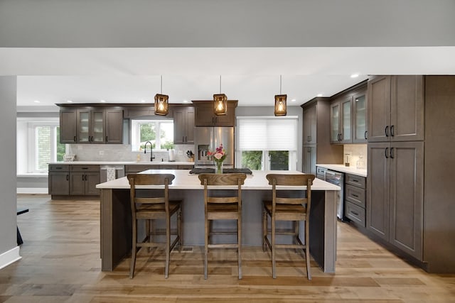 12533 Rosewood Dr, Homer Glen, IL 60491 - kitchen with stainless steel appliances, light countertops, dark brown cabinets, tasteful backsplash, and recessed lighting