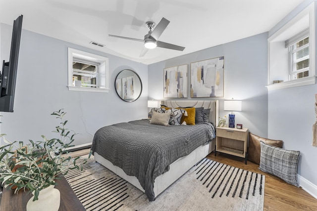 4717 N Kenmore Ave Unit Gs, Chicago, IL 60640 - bedroom with multiple windows, wood finished floors, and a ceiling fan