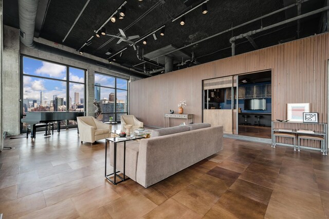 1530 S State St Unit 18A-B, Chicago, IL 60605 - living area with rail lighting, a city view, wood walls, and a high ceiling