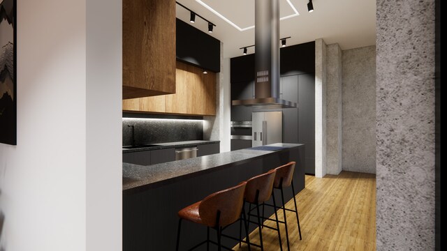 1530 S State St Unit 18A-B, Chicago, IL 60605 - kitchen with modern cabinets, dark countertops, a kitchen breakfast bar, light wood-style flooring, and rail lighting