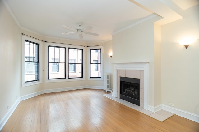 7631 N Eastlake Ter Unit 2C, Chicago, IL 60626 - unfurnished living room featuring radiator, a ceiling fan, light wood-style floors, a tiled fireplace, and healthy amount of natural light